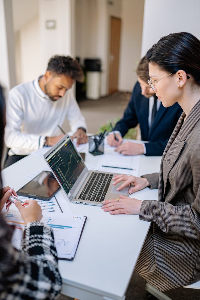 Team members reviewing work on a screen